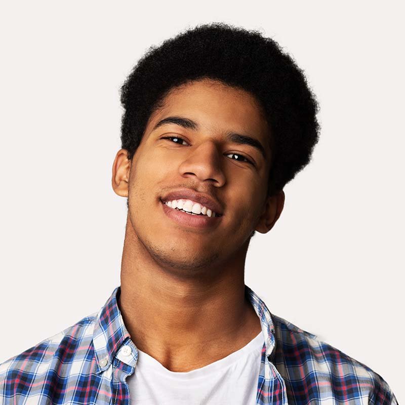 Portrait of happy young african guy on white backg HELQBXA.jpg