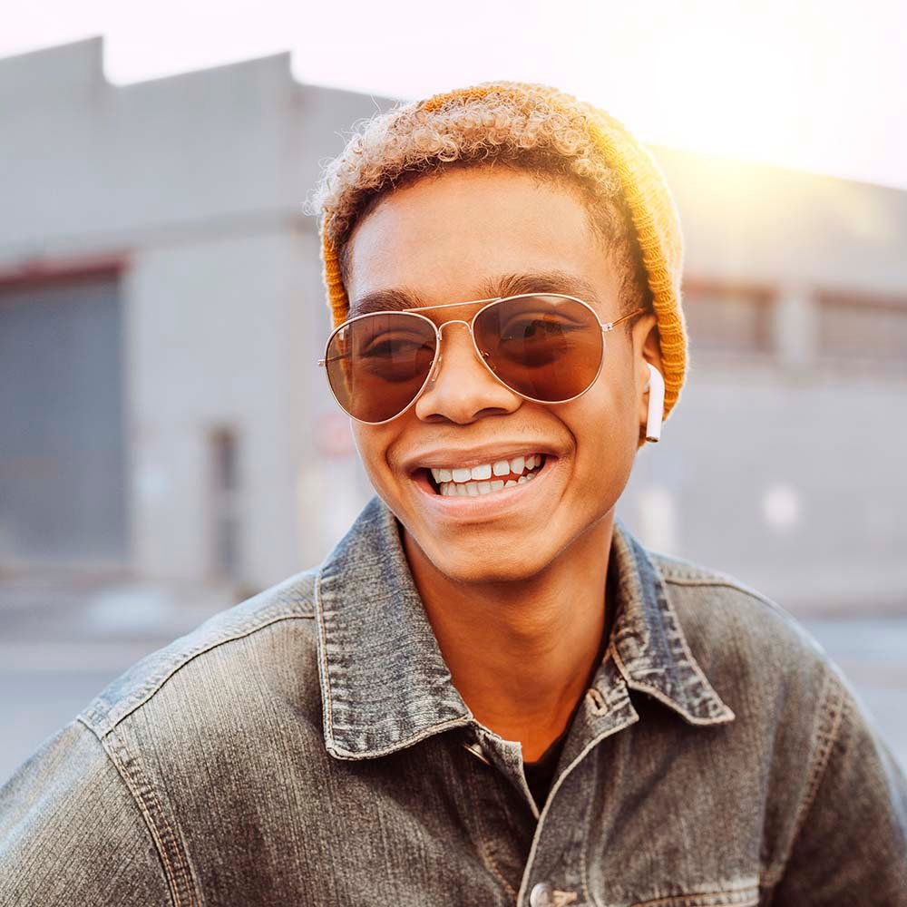 Young afro latin boy listens podcast with earphone 2UFPTH8.jpg